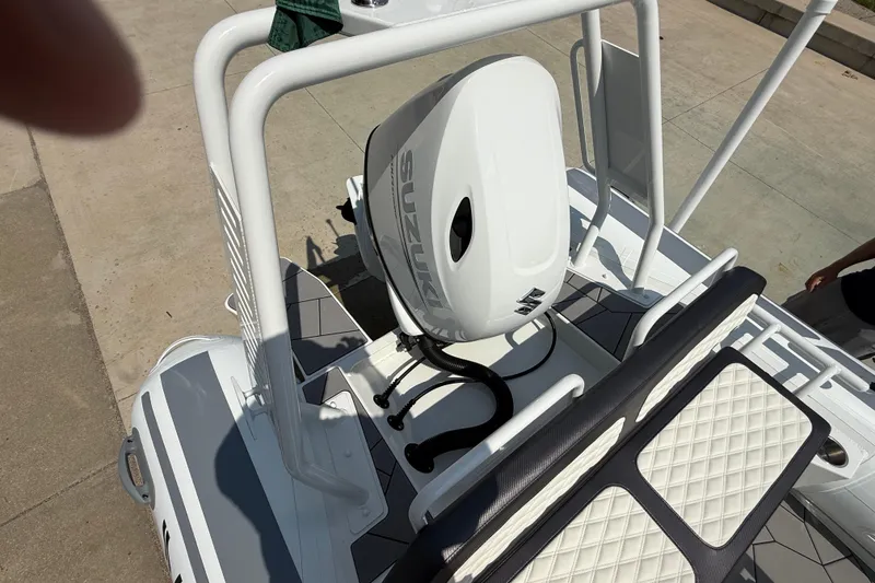 Slide: The Image of 2025 Highfield Sport 560 boat with Suzuki outboard motor, featuring sleek design and cushioned seating. - 24