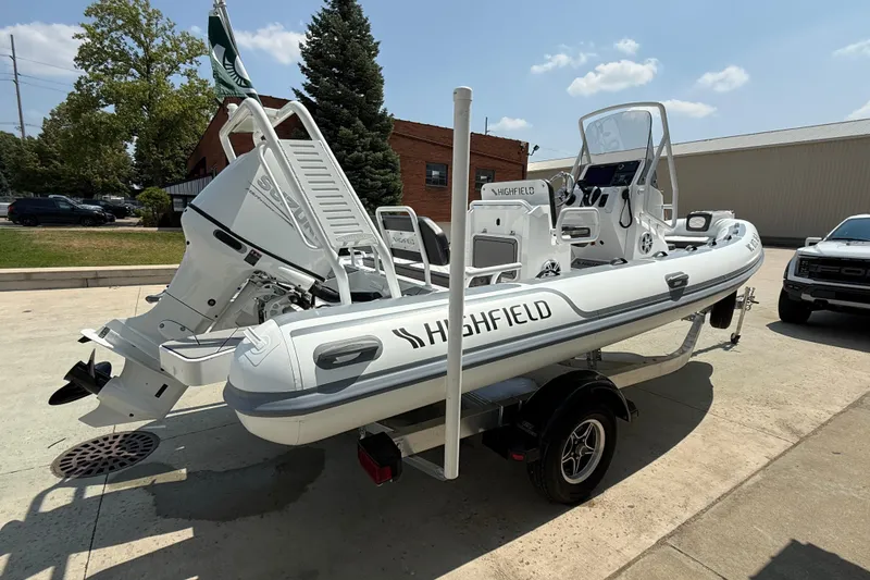 Slide: The Image of 2025 Highfield Sport 560 boat on trailer, featuring Suzuki outboard motor, parked outdoors. - 3