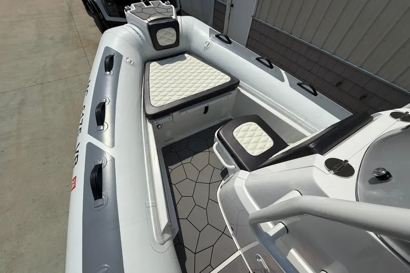 Slide: The Image of 2025 Highfield Sport 560 boat interior with cushioned seating and modern design. - 6