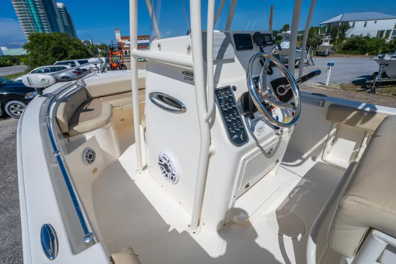 Slide: The Image of 2016 Cobia 201 Center Console boat interior with steering wheel and seating. - 14