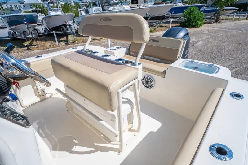 Slide: The Image of 2016 Cobia 201 Center Console boat interior with seating and steering wheel. - 16