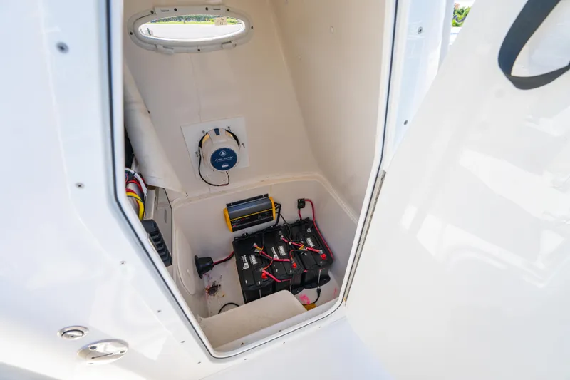 Slide: The Image of 2016 Cobia 201 Center Console battery compartment with wiring and equipment. - 20