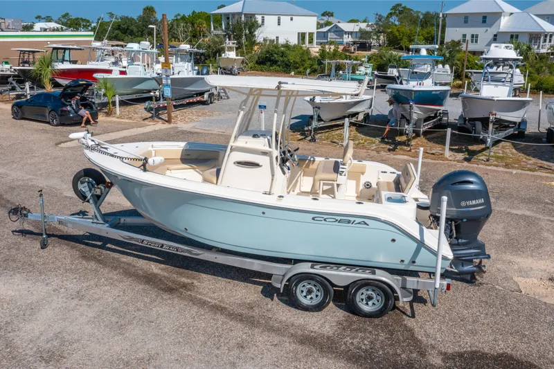 Slide: The Image of 2016 Cobia 201 Center Console boat on trailer, parked in marina with other boats. - 4