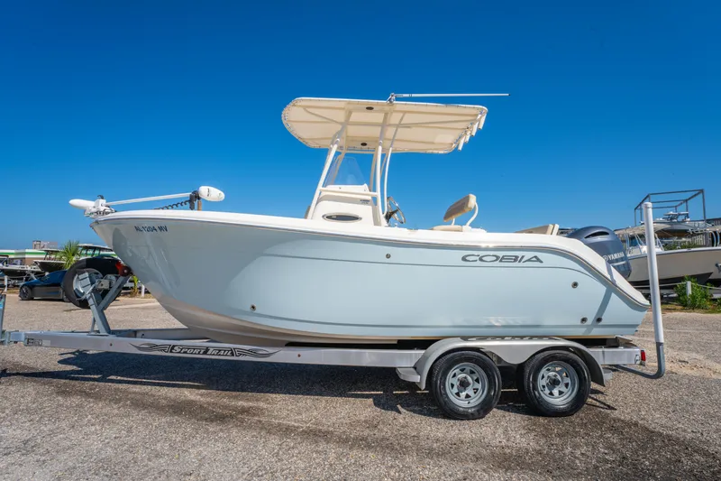 Slide: The Image of 2016 Cobia 201 Center Console boat on trailer under clear blue sky. - 8