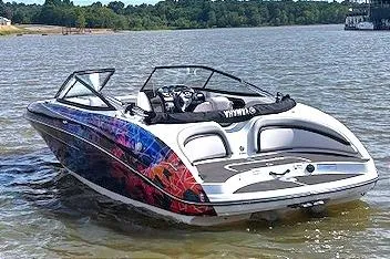 Slide: The Image of 2010 Yamaha Boats 212SS on water, vibrant design, scenic background. - 1