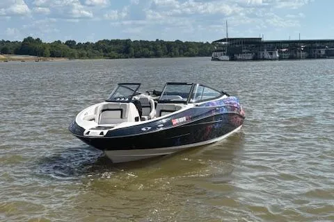 Slide: The Image of 2010 Yamaha Boats 212SS on a lake with a marina in the background. - 12