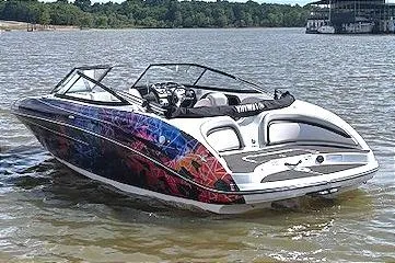 Slide: The Image of 2010 Yamaha Boats 212SS with colorful graphics on a lake. - 2