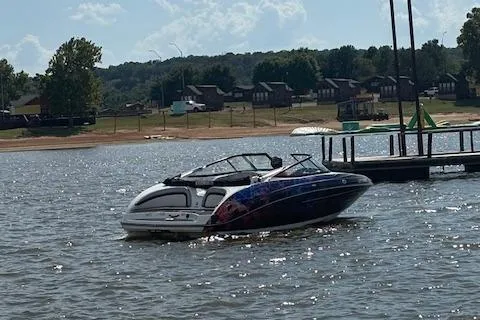 Slide: The Image of 2010 Yamaha Boats 212SS on a lake near a dock, with scenic background. - 4