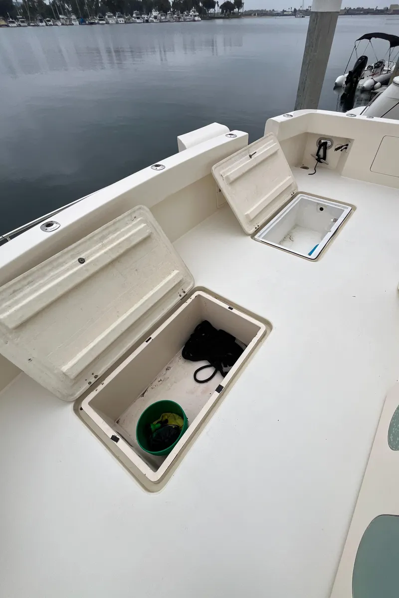 Slide: The Image of 1999 Mikelson Long-Range Luxury Sportfisher deck with open storage compartments. - 14