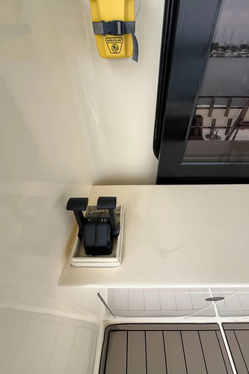 Slide: The Image of 1999 Mikelson Long-Range Luxury Sportfisher interior with control levers and safety equipment. - 15