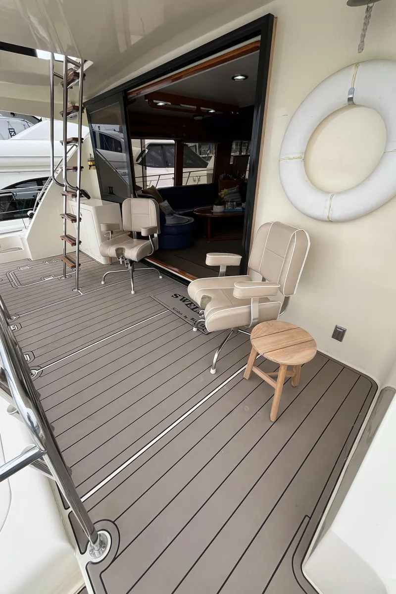 Slide: The Image of 1999 Mikelson Long-Range Luxury Sportfisher deck with seating and life preserver. - 17