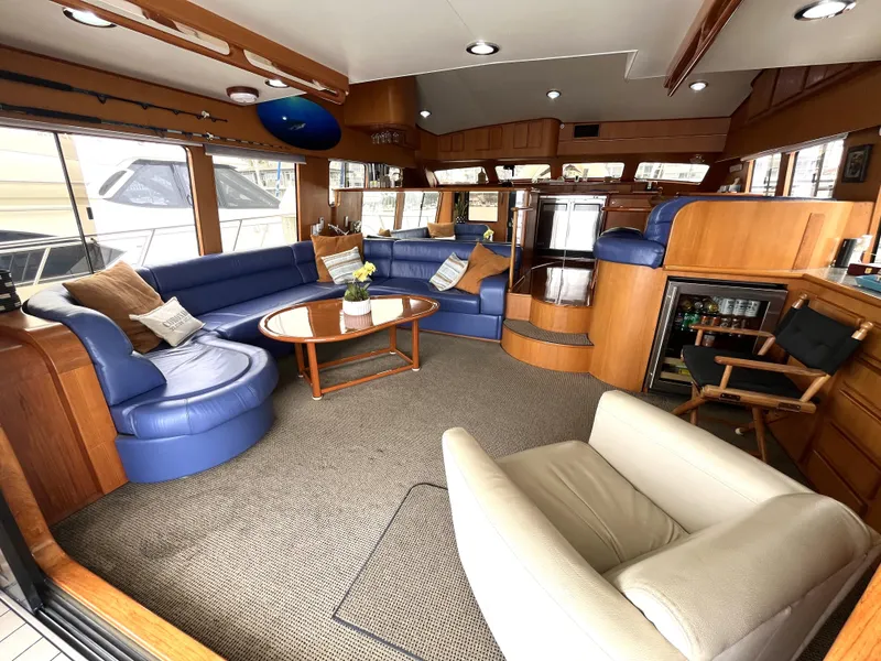 Slide: The Image of Luxurious interior of a 1999 Mikelson Long-Range Luxury Sportfisher yacht with plush seating. - 19