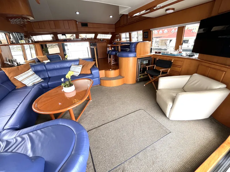Slide: The Image of Luxurious interior of a 1999 Mikelson Long-Range Luxury Sportfisher with blue seating and wood accents. - 20