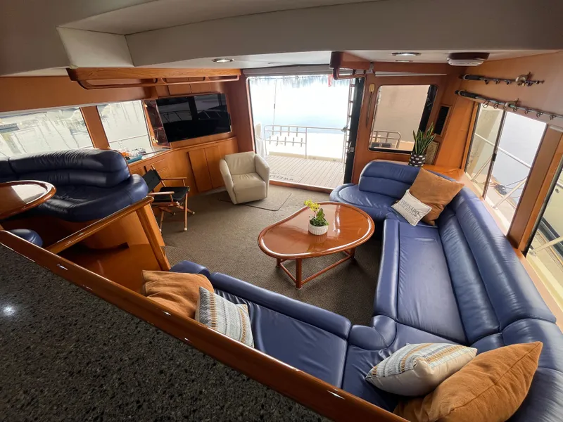 Slide: The Image of Luxurious interior of a 1999 Mikelson Long-Range Sportfisher with blue leather seating and modern amenities. - 22