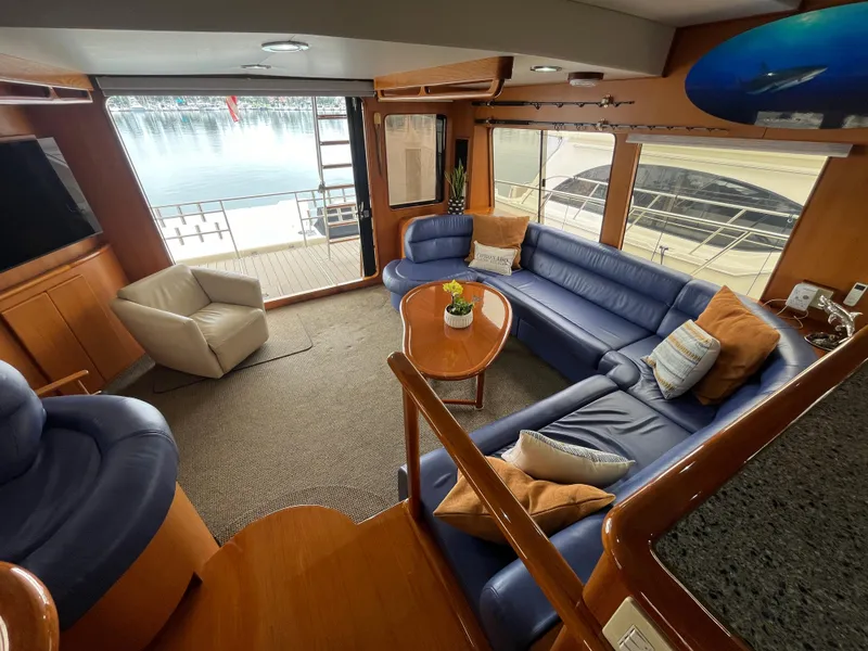 Slide: The Image of Luxurious interior of a 1999 Mikelson Long-Range Sportfisher with plush seating and elegant decor. - 23
