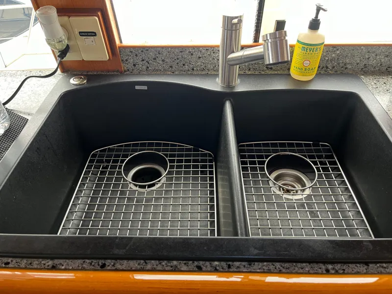 Slide: The Image of Double kitchen sink with grid racks in a 1999 Mikelson Long-Range Luxury Sportfisher. - 31