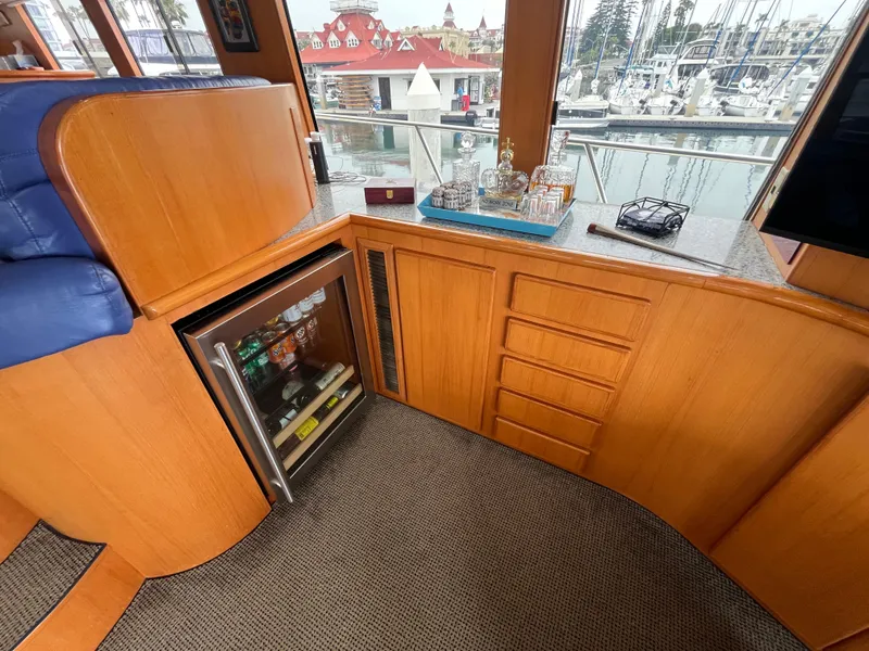 Slide: The Image of 1999 Mikelson Long-Range Luxury Sportfisher interior with minibar and marina view. - 32