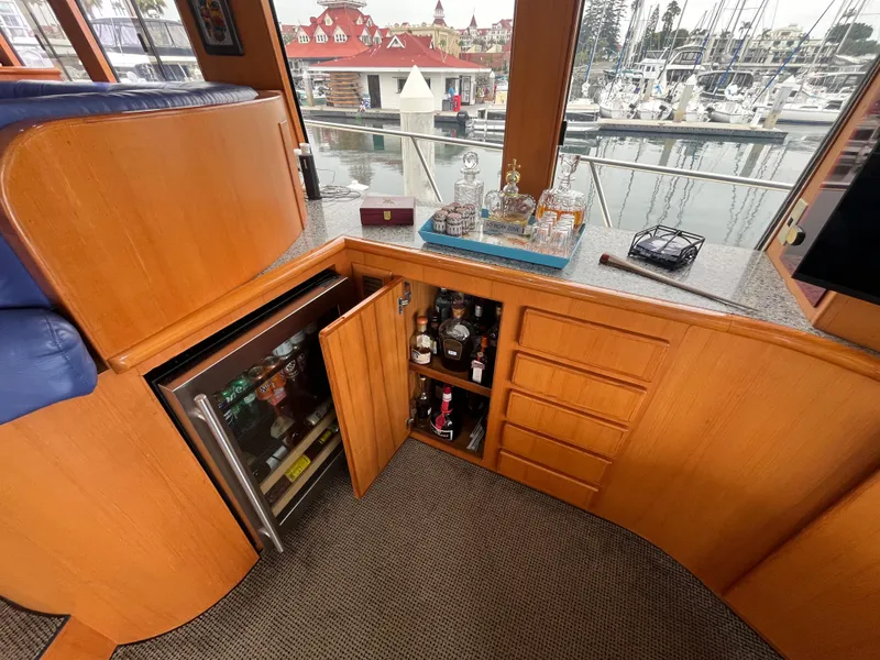 Slide: The Image of Luxurious interior of a 1999 Mikelson Long-Range Sportfisher with bar and marina view. - 33