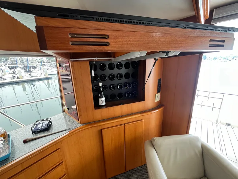 Slide: The Image of Interior of 1999 Mikelson Long-Range Luxury Sportfisher with wine rack and marina view. - 35