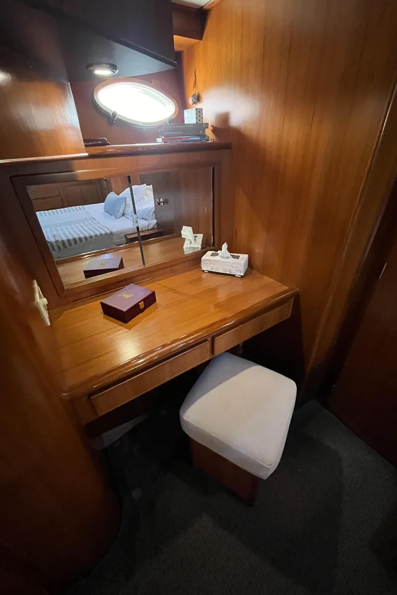 Slide: The Image of Luxurious wooden vanity area in a 1999 Mikelson Long-Range Luxury Sportfisher yacht. - 43