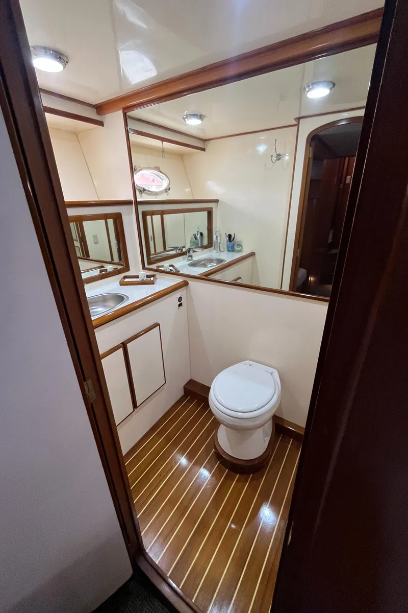 Slide: The Image of 1999 Mikelson Long-Range Luxury Sportfisher bathroom with wood flooring and modern fixtures. - 44