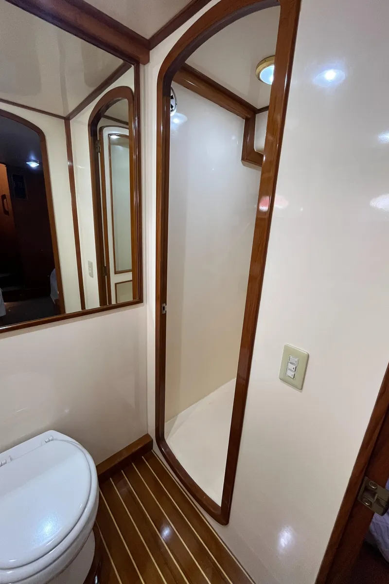 Slide: The Image of 1999 Mikelson Long-Range Luxury Sportfisher bathroom with wood accents and modern fixtures. - 45