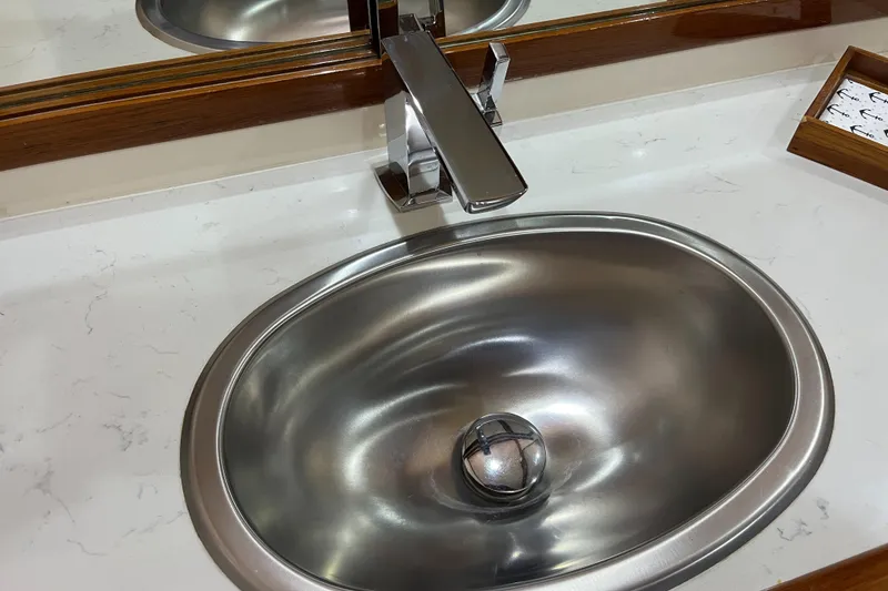 Slide: The Image of Stainless steel sink with modern faucet on Mikelson 1999 luxury sportfisher yacht. - 46