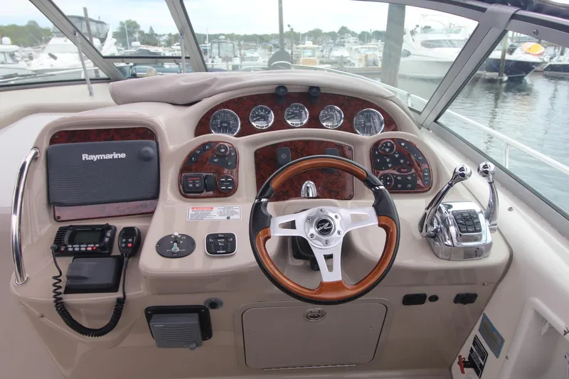 Slide: The Image of 2008 Sea Ray 340 Sundancer helm with Raymarine electronics and wood-accented steering wheel. - 11