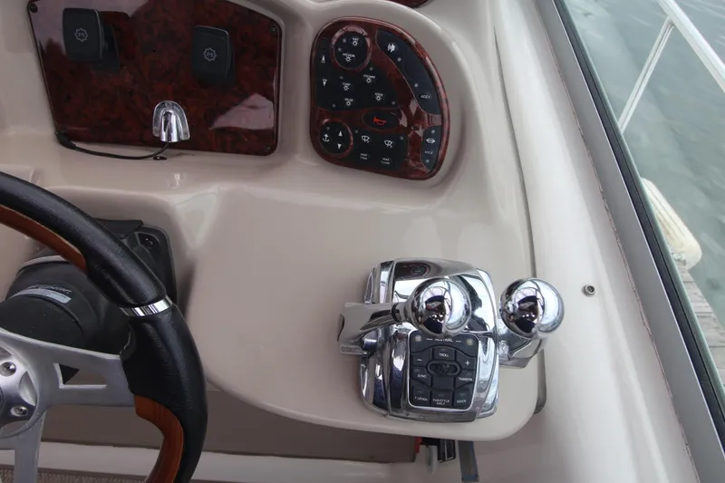 Slide: The Image of 2008 Sea Ray 340 Sundancer helm with controls and steering wheel. - 13