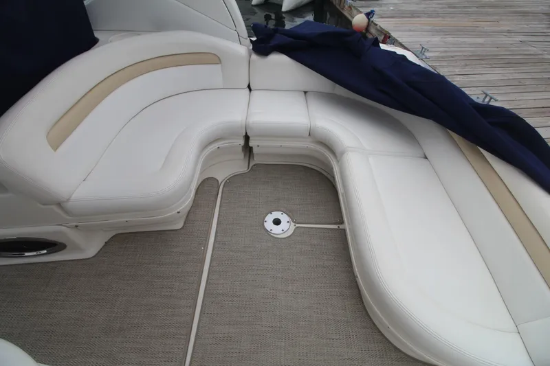Slide: The Image of 2008 Sea Ray 340 Sundancer boat interior with white cushioned seating and carpeted floor. - 15