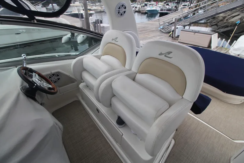 Slide: The Image of 2008 Sea Ray 340 Sundancer helm with dual seats and steering wheel, docked at marina. - 16