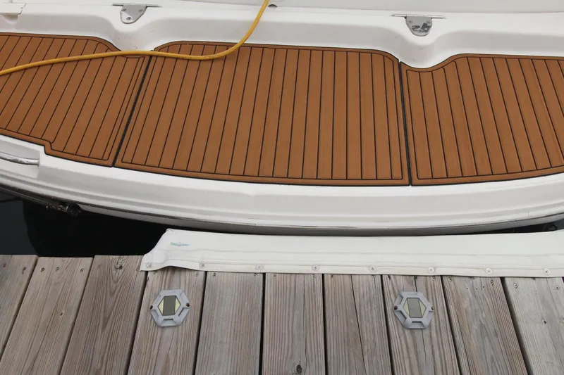 Slide: The Image of 2008 Sea Ray 340 Sundancer swim platform with teak decking at a dock. - 2
