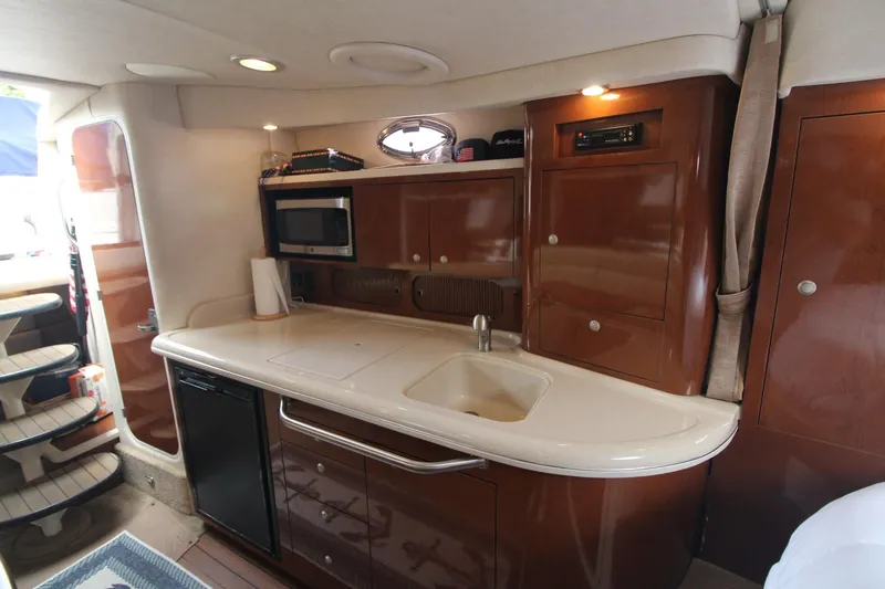 Slide: The Image of Interior of 2008 Sea Ray 340 Sundancer yacht with kitchenette and modern amenities. - 21