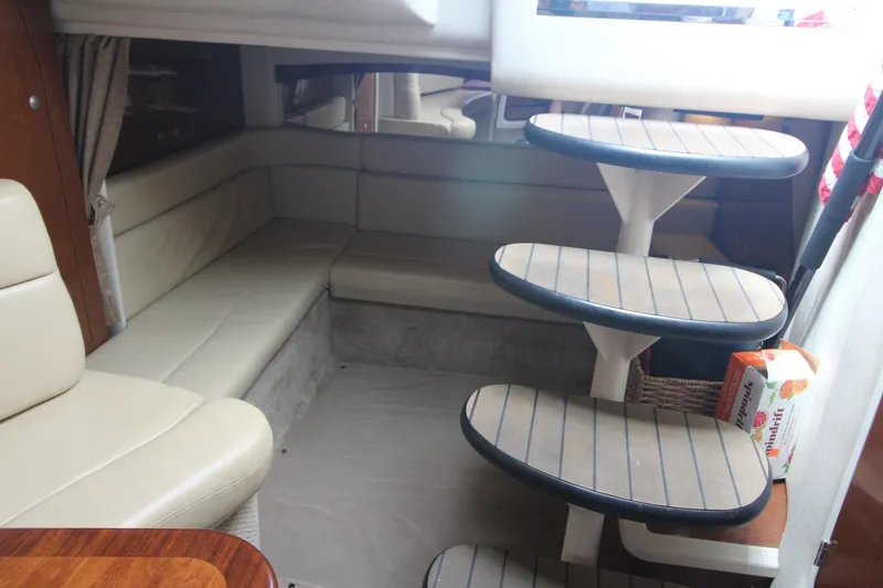 Slide: The Image of Interior of 2008 Sea Ray 340 Sundancer with beige seating and curved steps. - 23
