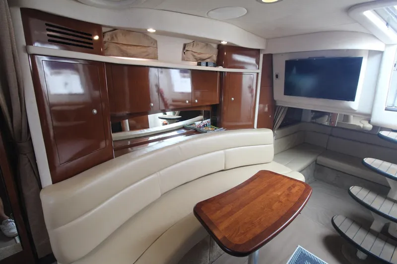Slide: The Image of Luxurious interior of 2008 Sea Ray 340 Sundancer yacht with leather seating and wooden table. - 24