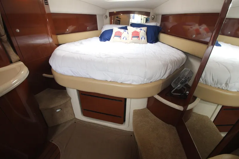 Slide: The Image of 2008 Sea Ray 340 Sundancer cabin with cozy bed and nautical decor. - 26