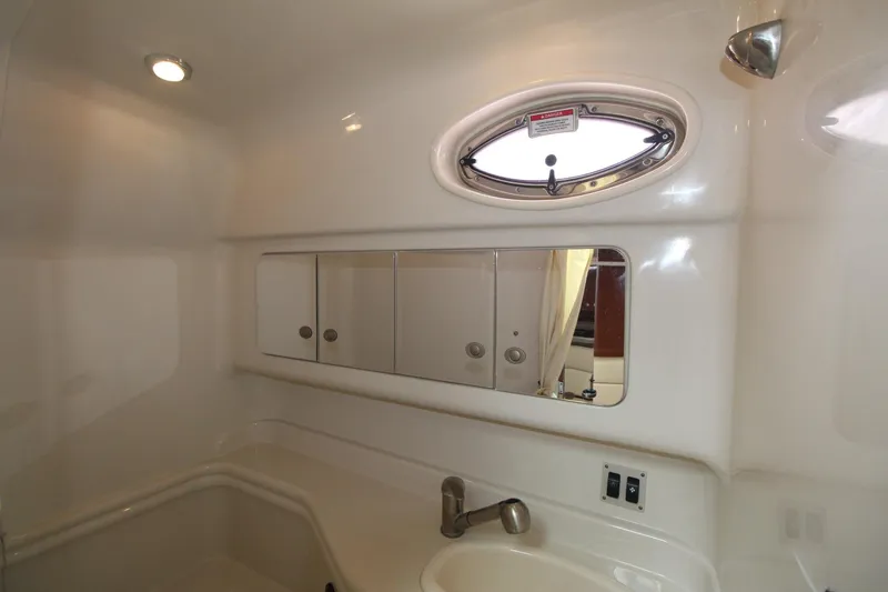Slide: The Image of 2008 Sea Ray 340 Sundancer bathroom with mirror, sink, and porthole window. - 29