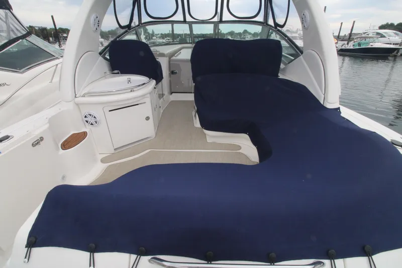 Slide: The Image of 2008 Sea Ray 340 Sundancer boat interior with blue covers, docked at marina. - 3