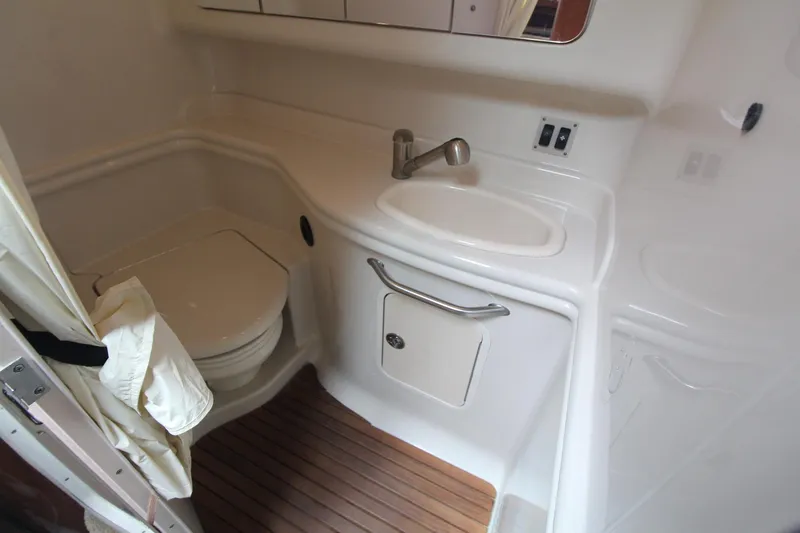 Slide: The Image of 2008 Sea Ray 340 Sundancer bathroom with toilet, sink, and wooden floor. - 30