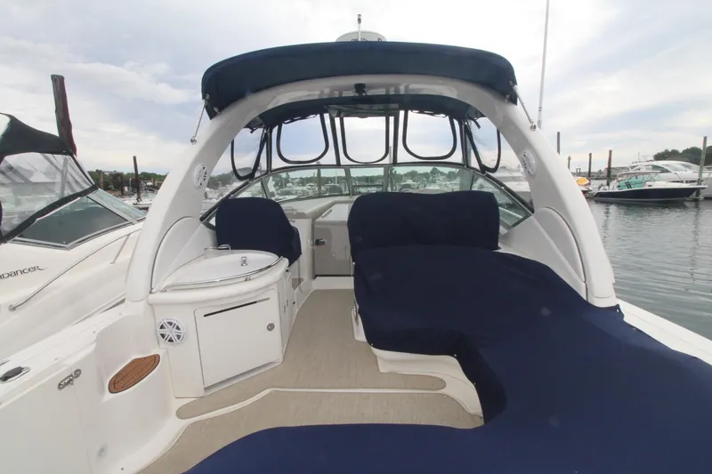 Slide: The Image of 2008 Sea Ray 340 Sundancer yacht interior with blue seating, docked at marina. - 4