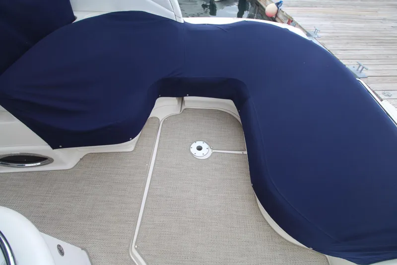 Slide: The Image of 2008 Sea Ray 340 Sundancer boat seating area with navy blue cover. - 5