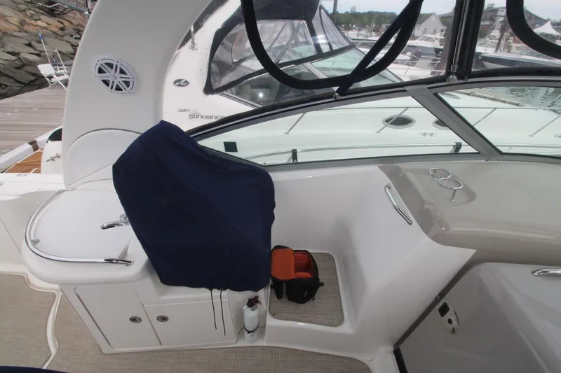 Slide: The Image of 2008 Sea Ray 340 Sundancer cockpit with covered seat and dashboard view. - 7