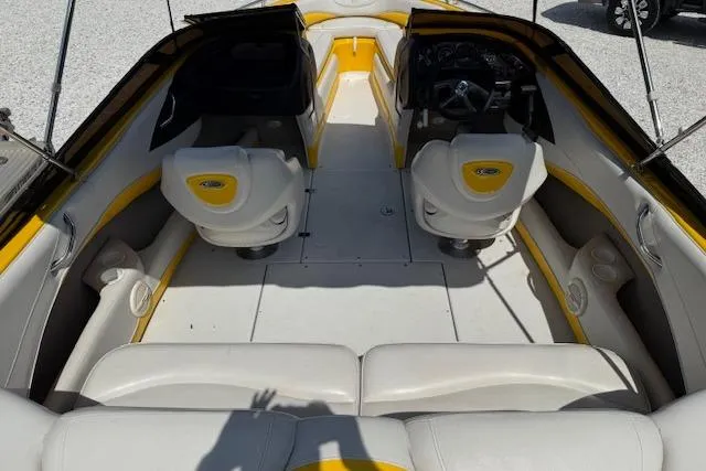 Slide: The Image of 2005 Crownline 210 LPX boat interior with yellow accents and dual seating arrangement. - 10
