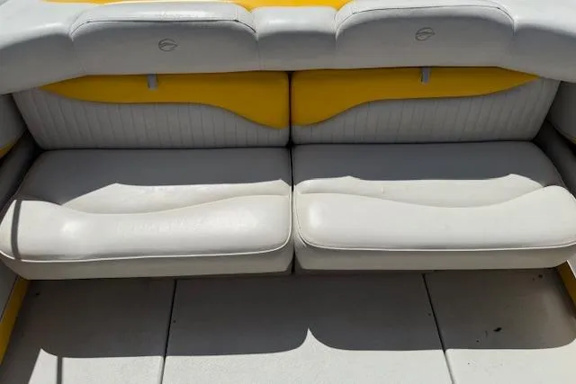 Slide: The Image of 2005 Crownline 210 LPX boat interior with yellow and white seating. - 12