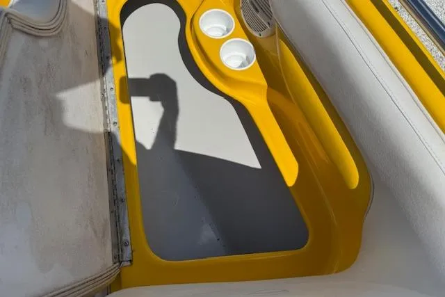 Slide: The Image of 2005 Crownline 210 LPX boat interior with yellow accents and cup holders. - 7