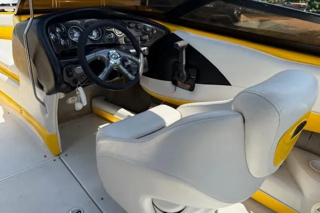 Slide: The Image of 2005 Crownline 210 LPX boat interior with steering wheel and white seating. - 8