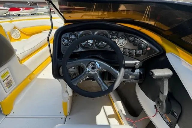 Slide: The Image of 2005 Crownline 210 LPX boat interior with steering wheel and dashboard controls. - 9