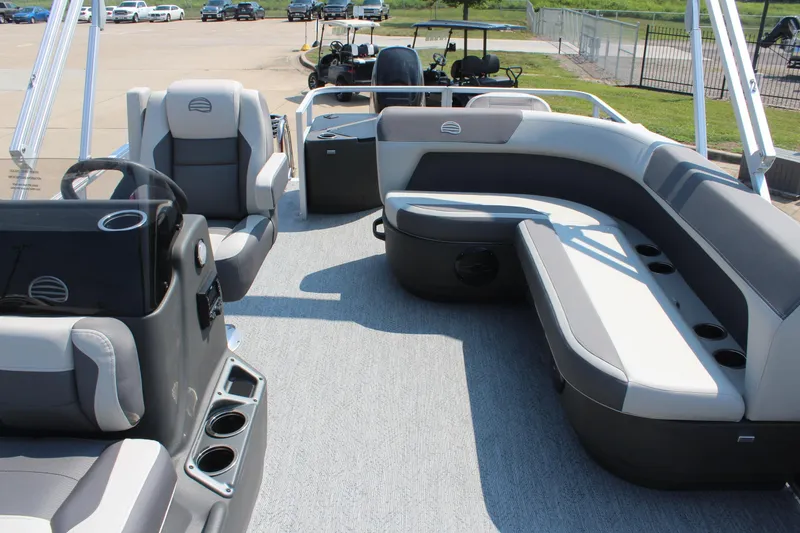Slide: The Image of 2026 Sun Tracker Bass Buggy 18 DLX pontoon boat interior with seating and steering console. - 13