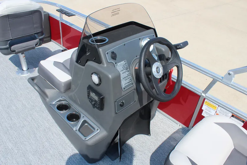 Slide: The Image of 2026 Sun Tracker Bass Buggy 18 DLX boat console with steering wheel and seating. - 15