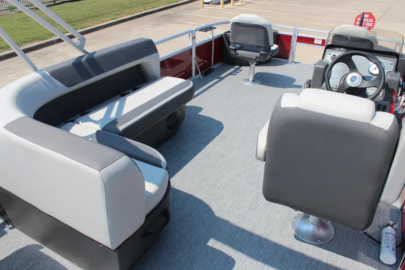 Slide: The Image of 2026 Sun Tracker Bass Buggy 18 DLX pontoon boat interior with seating and steering console. - 18